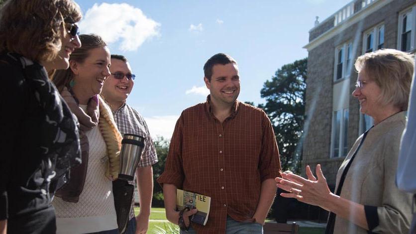 LTSS students talk with a professor outside after a class