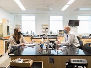 Dr. Daniel Grimm talks with a student.