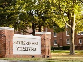 View of entrance to campus and university sign 